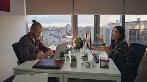 Focused-managers-talking-together-at-room-closeup.-Business-team-working-sunset