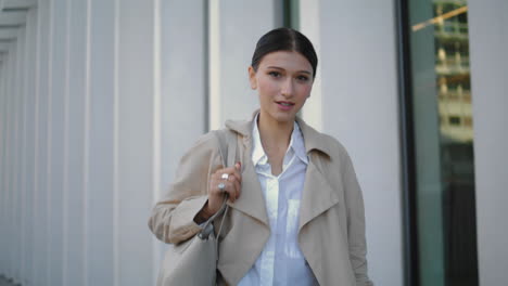 Confident-businesswoman-going-work-at-building-close-up.-Girl-walking-vertically