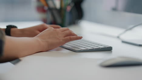 Developer-hands-coding-keyboard-light-interior-close-up.-Woman-working-computer