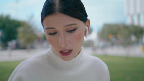 Worried-businesswoman-talking-headphones-outdoors-close-up.-Busy-woman-talking.