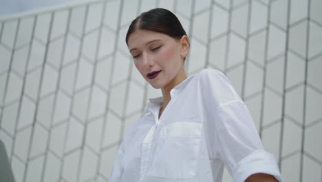 Businesswoman-looking-laptop-standing-in-front-city-building-vertically-close-up