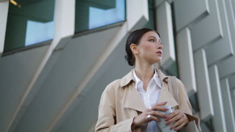 Woman-standing-street-coffee-takeaway-close-up.-Lady-drinking-hot-beverage.