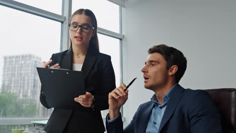 Company-boss-give-instruction-in-office-closeup.-Beautiful-assistant-take-notes