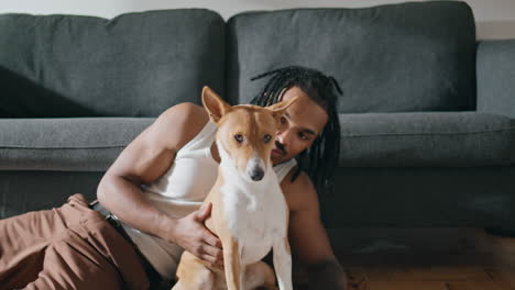 Hombre-Feliz-Acariciando-Al-Perro-En-El-Primer-Plano-De-Casa.-Rastas-Chico-Acariciando-A-Un-Amigo-Canino