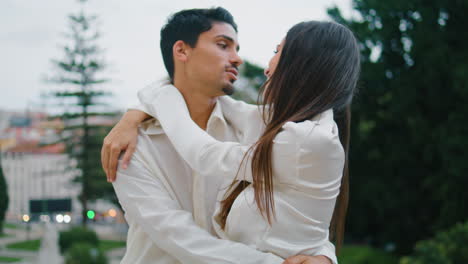 Loving-couple-touching-noses-urban-place-closeup.-Happy-pair-embracing-flirting