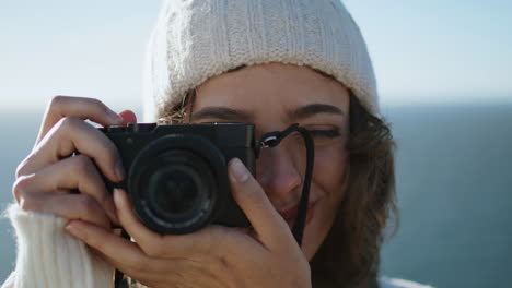 Portrait-photographer-taking-picture-with-analog-camera.-Beautiful-tourist-hold