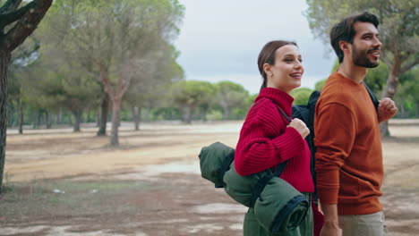 Couple-going-hike-nature-with-backpacks.-Happy-family-walking-on-autumn-forest.