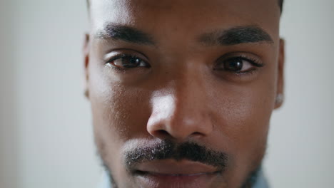 Serious-man-looking-camera-home-alone-portrait.-Brown-skin-student-staring-lens