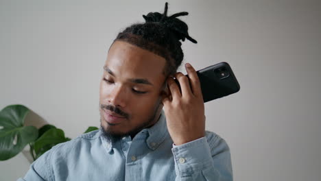 Attentive-freelancer-using-smartphone-indoors-closeup.-Man-listening-message