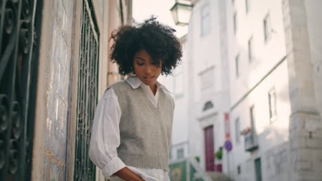 Model-walking-old-street-wearing-white-shirt-close-up.-Girl-enjoy-town-stroll.