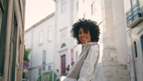 Woman-enjoy-city-stroll-sitting-railings-near-road-close-up.-Girl-walking-town.