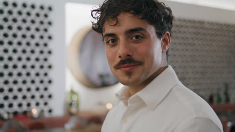 Portrait-attractive-italian-man-standing-in-winery-cellar-wearing-white-shirt.