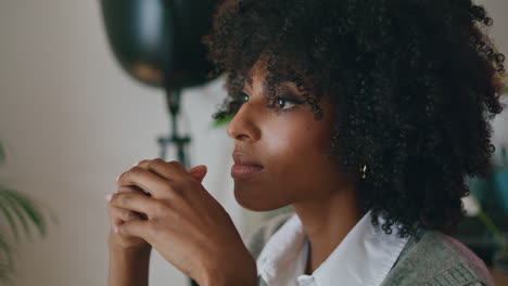 Retrato-De-Una-Mujer-Africana-Pensativa-Con-Peinado-Rizado-Mirando-A-Distancia-En-El-Interior.