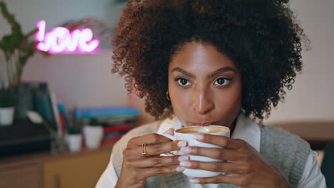 Woman-tasting-aromatic-latte-sitting-restaurant-closeup.-Girl-holding-cup-coffee