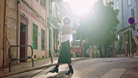 Happy-woman-spinning-road-sunny-city-street.-Girl-enjoy-sunlight-on-crosswalk.