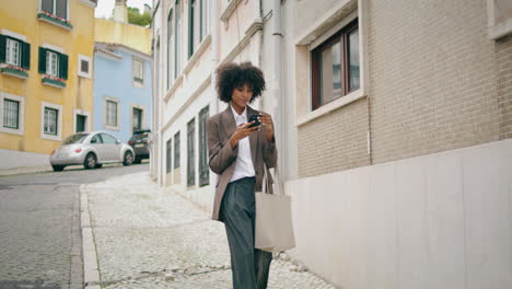 Girl-using-smartphone-selfie-standing-on-street.-Young-woman-taking-photo.