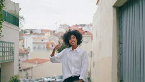 Playful-woman-running-street-holding-jacket.-Happy-girl-rejoicing-town-weekend.