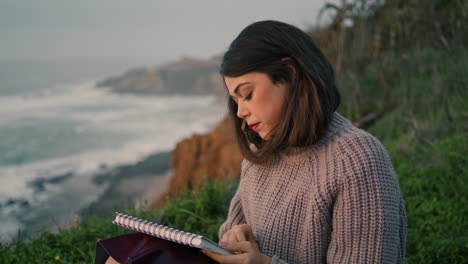 Woman-drawing-evening-beach-closeup.-Girl-artist-making-sketch-gloomy-seascape.