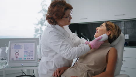 Professional-ultrasound-face-rejuvenation-making-for-woman-in-clinic-close-up.
