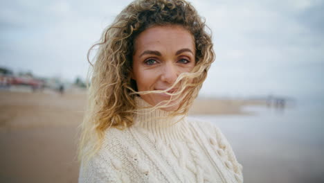 Carefree-woman-enjoying-ocean-weekend-closeup.-Attractive-blonde-looking-camera