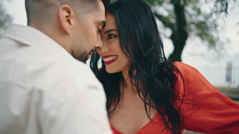 Woman-dancer-moving-man-in-city-park-close-up.-Energetic-couple-performing-salsa