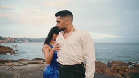 Hot-hispanic-dancers-performing-seductive-choreography-style-on-cloudy-beach.