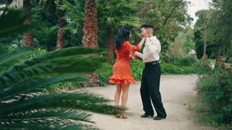 Sexy-samba-dancers-moving-sensually-performing-latino-choreography-in-city-park.