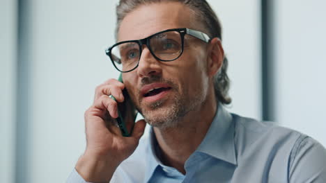 Smiling-businessman-speaking-mobile-phone-closeup.-Man-talking-cell-emotionally