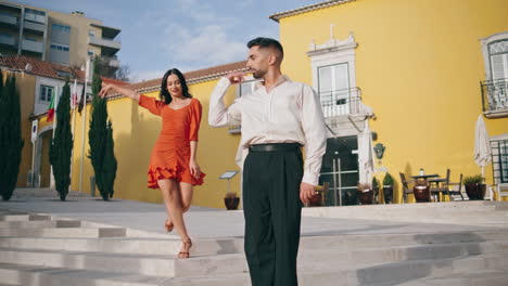 Dancers-latin-american-style-performing-on-town-stairs.-Passionate-couple-moving