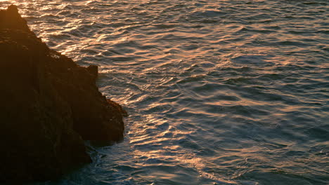 Calm-water-washing-mountain-at-morning-closeup.-Tranquil-waves-moving-surface