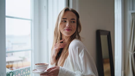 Relaxed-lady-flirting-camera-morning-window-place-portrait.-Lovely-girl-posing