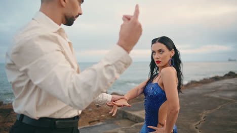 Passionate-woman-dancing-partner-at-cloudy-nature.-Dancers-performing-on-beach.