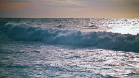 Foamy-waves-rolling-sunrise-shore-slow-motion.-Beautiful-seaside-evening-view.