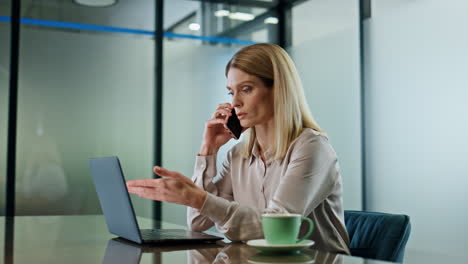 Serious-executive-calling-phone-office-closeup.-Businesswoman-talking-cellphone