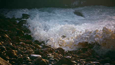 Foaming-sea-splashing-stones-coastline-in-morning-closeup.-Summer-ocean-weekend