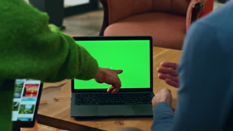 Colleagues-pointing-mockup-laptop-screen-indoors-closeup.-Man-woman-having-call