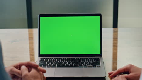 Business-team-using-green-screen-laptop-lobby-closeup.-Coworkers-working-online
