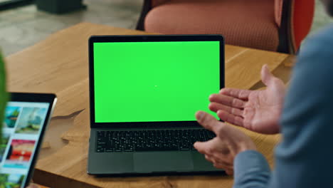 Man-gesturing-hands-chromakey-laptop-chat-indoors.-Agents-offering-on-tablet