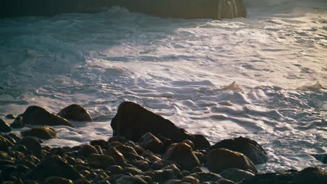 Foaming-shallow-sea-water-washing-rocky-coast-closeup.-Beautiful-ocean-waving