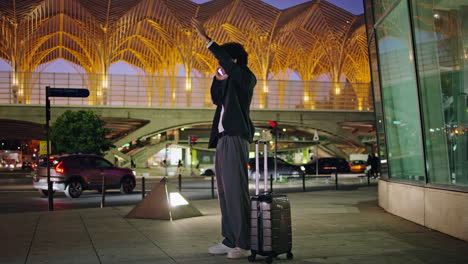 Arrived-businessman-waving-hand-at-night-street.-Leader-person-waiting-taxi