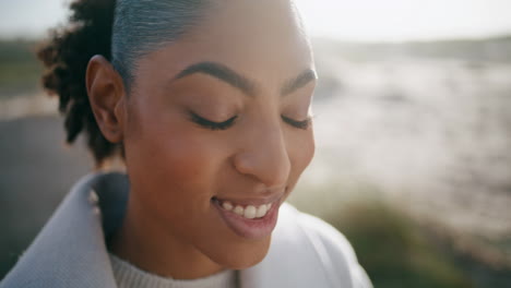 Closeup-calm-woman-posing-at-sand-dunes.-Attractive-african-american-enjoying