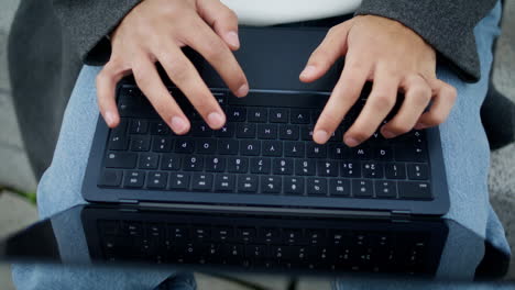 Student-hands-working-keyboard-outdoor-closeup.-Unknown-man-typing-laptop-device