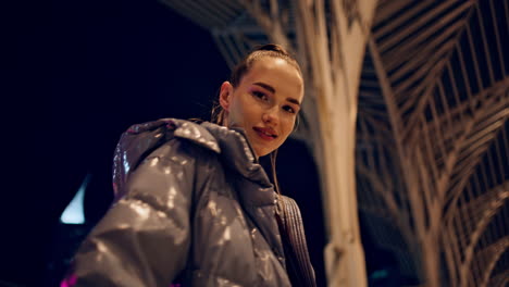 Woman-enjoy-night-walk-looking-camera-smiling-closeup.-Girl-posing-gothic-town