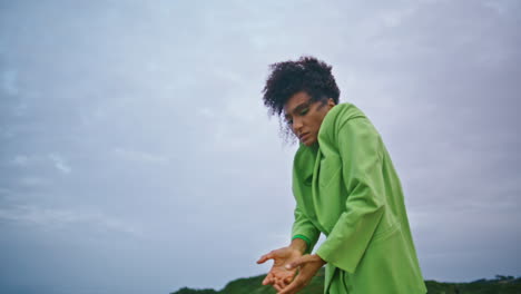 Emotional-girl-performer-dancing-at-night-outdoors-closeup.-African-woman-moving