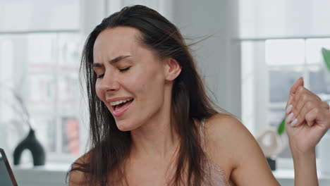 Excited-girl-drying-hair-at-bathroom-portrait.-Dancing-woman-touching-hairstyle