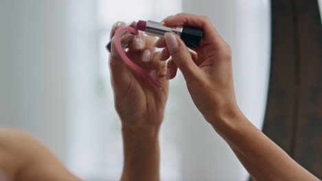 Woman-hand-drawing-lipstick-heart-bathroom-mirror-closeup.-Lady-putting-symbol