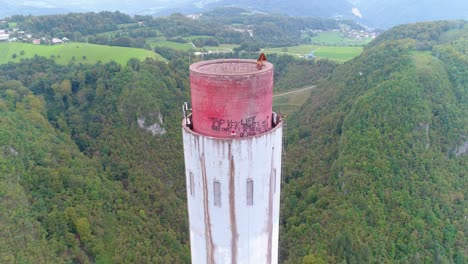 Aerial-of-the-topmost-part-of-the-tallest-chimney-stack-in-Europe,-standing-high-in-the-sky-at-Trbovlje-Power-Station,-Slovenia