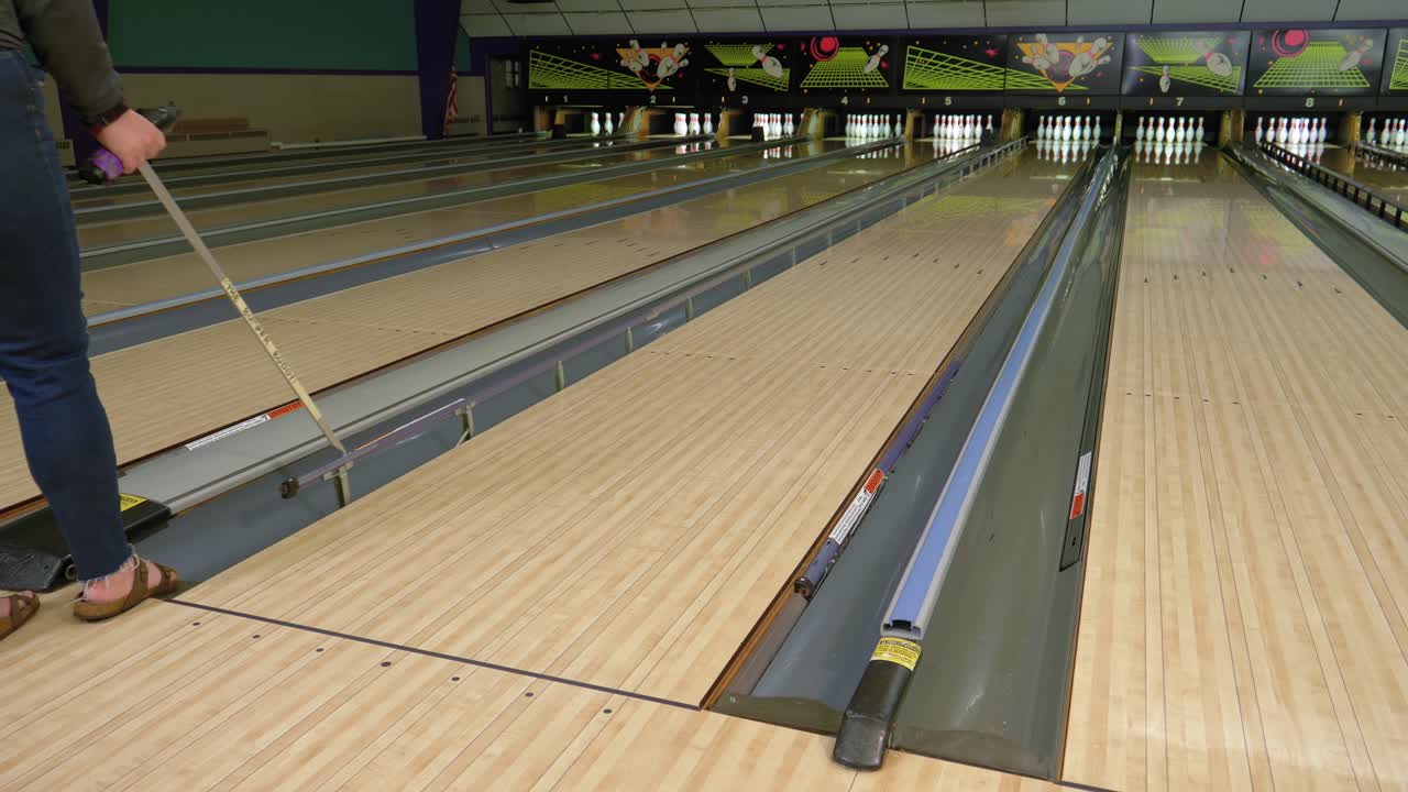 Female Bowling Alley Employee Manually Pulls Up Bumpers For ...