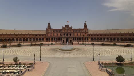 Aerial-view-of-Plaza-de-EspaÃ±a-square,-with-jib-movement-down-revealling-statue