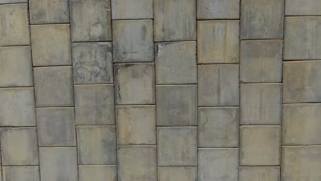 Cement-tiles-of-big-vertical-wall-of-dam-built-on-valley-of-La-Huasteca-in-Monterrey,-Mexico